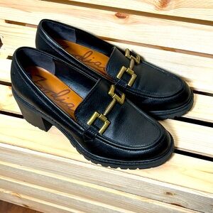 Women’s size 8.5 black chunky loafers with gold buckle detail.